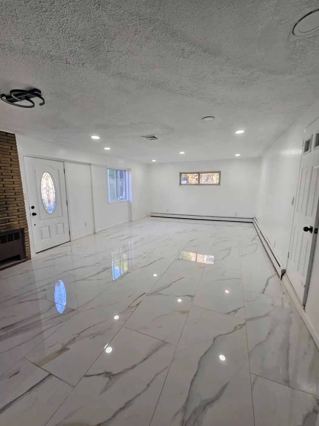 Completed bright interior renovation with new tile and recessed lighting